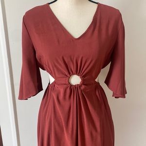 Medium ginger/rust color dress.